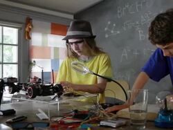 MS PAN Cute teenage boys and girl making engineering race car model at home while learning and having fun / Pasadena, California, United States   Stock Footage