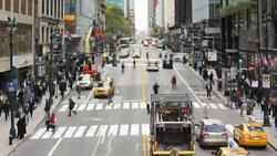 Pedestrians maneuver across a crosswalk on 42nd Street in New York City. Stock Footage