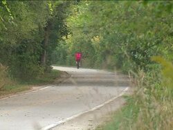 Person Riding Bike On Path Stock Footage