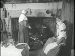 A young boy rotates a turkey over a fire in preparation for the first Thanksgiving feast in 1621. News Clip