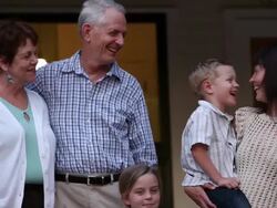 MS TU PAN R/F portrait of multigenerational family outside on porch of home Stock Footage