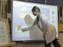 MS Teacher working on preparing different lessons on smart-board inside classroom inside school / Minneapolis, Minnesota, United States Stock Footage