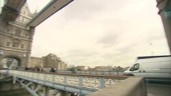 Traffic and pedestrians cross the Tower Bridge in London. Stock Footage