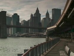 The walkway under the FDR overpass by the east river between the Manhattan Bridge and the Brooklyn Bridge looking towards lower Manhattan Stock Footage