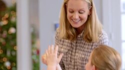 Mother and daughter roll cookie dough into balls and pound on kitchen counter-top Stock Footage