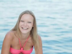 Attractive young woman flirting on sea background Stock Footage