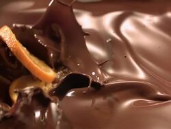 orange slices falling into melted chocolate Stock Footage