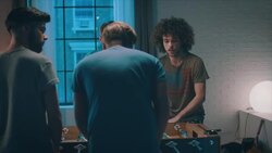 Guys playing tabletop soccer in apartment Stock Footage