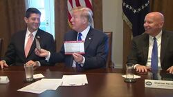 Trump Plants Kiss on Republican Tax Plan Instructional Video