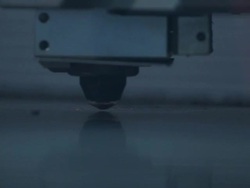 Slow motion close up of laser cutter as it punches holes in a sheet of metal. Stock Footage