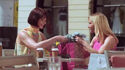 TU Woman showing what she bought to friend over coffee Stock Footage