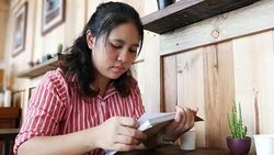 woman reading book in cafe Stock Footage