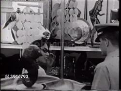 1965: SUBIC BAY NAVY EXCHANGE: VS Lieutenant Virgil Jackson from USS Enterprise (CVN-65) shopping at busy NEX, VS People in shop, Virgil lifting, carrying away large box containing Sony Tapecorder TC-200 (basic reel-to-reel portable stereo recorder). Instructional Video