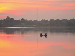 Fishermen at dawn long focus shot. Stock Footage