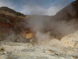 MS Steam rising from earth at Krysuvik Geothermal area and man standing on boardwalk / Reykjanes peninsula, Iceland   Stock Footage