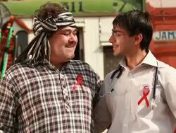 Portrait of a doctor and a truck driver with AIDS Ribbon on the chest giving thumbs up gesture, Ballabgarh, Haryana, India Stock Footage