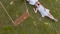 CS Young couple lying under a tree Stock Footage
