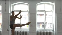 Male ballet dancer practicing splits in mid-air at studio Stock Footage