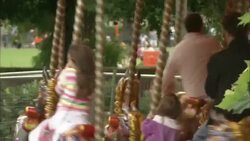 Children and adults ride a carousel in London. Stock Footage
