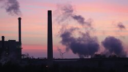 Sunset over the Iggesund paper board manufacturer in Workington, Cumbria, UK, at sunset, with wind turbines. The plant is powered by a biofuel power station, on site. Stock Footage