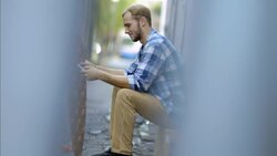 Skater texts on smartphone and takes photos of custom skateboard deck Stock Footage