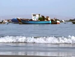 WS Shot of barge men working on boat / Paracas, Nazca, Peru Stock Footage