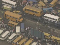MS AERIAL View of city market and traffic moving on street / Lagos, Nigeria Stock Footage