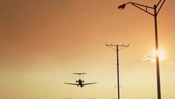 Plane flying in front of Sun Stock Footage