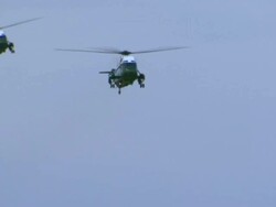 Marine 1 and escort choppers land, taxi, Marine opens hatch Stock Footage