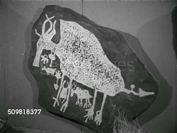 1952: NEW YORK: MUSEUM GALLERY: VS Brooklyn Museum exhibit replicas of early Native American pictographs,SOT Male educator talking w/ young teens about display, students making observations, what they think they mean. Instructional Video