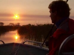 MS POV Shot of sun sets with man on boat / ghanzi district, ghanzi district, botswana Stock Footage