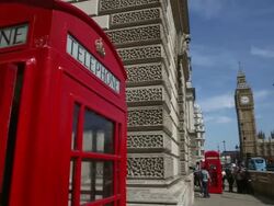 Close up of red phone booth, pan to right to long Stock Footage