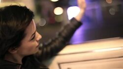 young woman riding down Las Vegas Strip in classic convertible waves her hand in the wind Stock Footage