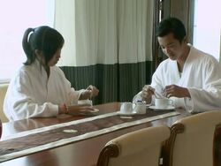 MS Couple drinking tea at table in hotel room / Sihanoukville, Cambodia Stock Footage