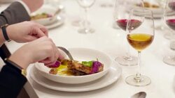 MS CU Woman eating roasted cornish game hen during dinner party Stock Footage