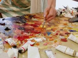 MS PAN TU Artists mixing color with brush / Lamy, New Mexico, United States Stock Footage