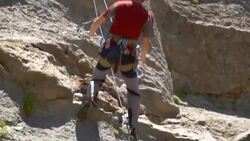 A rock climber falling and being saved by his rope. - Slow Motion Stock Footage