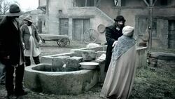 Nostradamus examines a village woman for illness near a well. Stock Footage