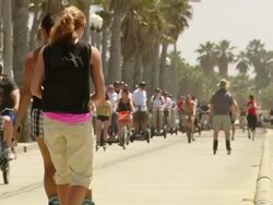 MS TU ZO Shot of people riding Segway on road by beach / Los Angeles, California, United States Stock Footage