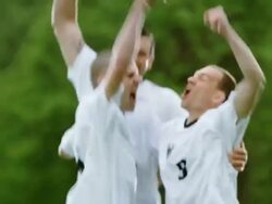 MS TU R/F professional soccer team celebrating together on field in rain storm after winning match Stock Footage