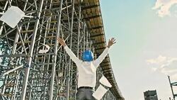 SLO MO Architect throwing blueprints at the construction site Stock Footage