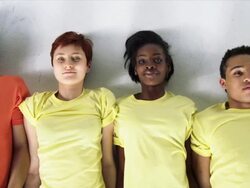 Row of People Lying Down on White Studio Floor, Closeup Stock Footage