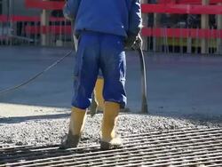 MS Workers Directing Concrete Onto The Construction Site Stock Footage