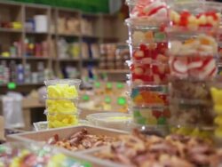 Woman buys jelly in candy shop Stock Footage