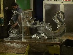 An artist chisels an ice sculpture depicting a dragon. Stock Footage