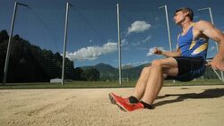 HD Super Slow-Mo: Athlete Landing In Sandpit Stock Footage