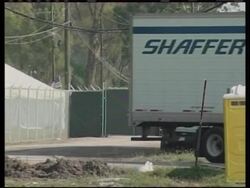 Refrigerated trucks bring bodies to makeshift morgue News Clip