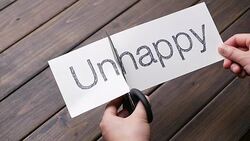 woman's hands cut paper by scissors on pattern wood plank Stock Footage