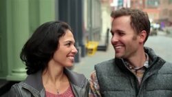 Happy New York couple walk hand-in-hand up Soho sidewalk, boyfriend stops to pull girl in for romantic kiss Stock Footage