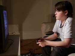 BOY AGED 12 PLAYING COMPUTER GAME Stock Footage